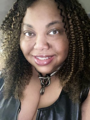 Self photo with plum lipstick and leather top.